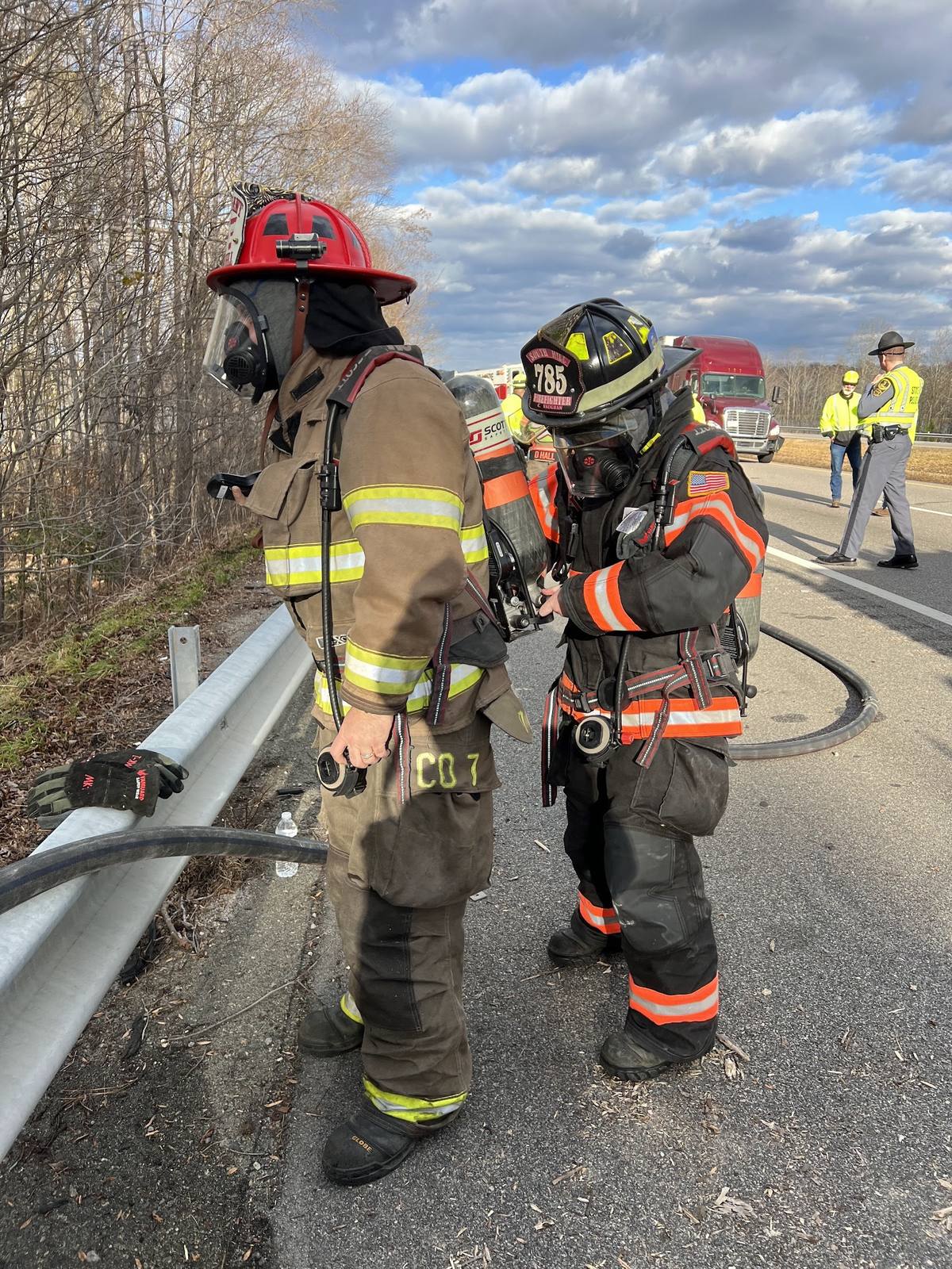 Two South Hill firefighters on air beside the guardrail at a highway incident, Interstate 85