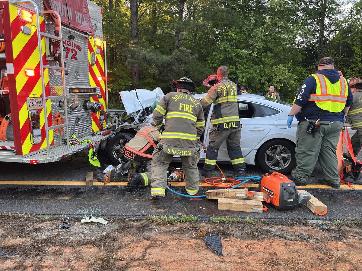 South Hill crew stabilising a sedan with cribbing during an extrication beside Engine 72