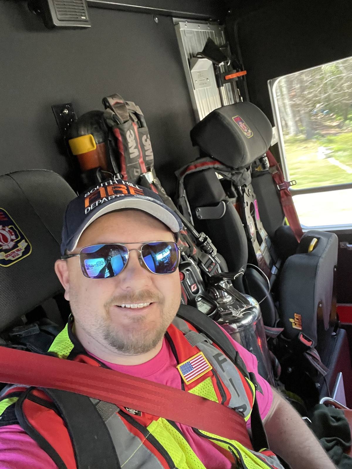 Derek Hazelwood in the cab of a South Hill engine responding to a call