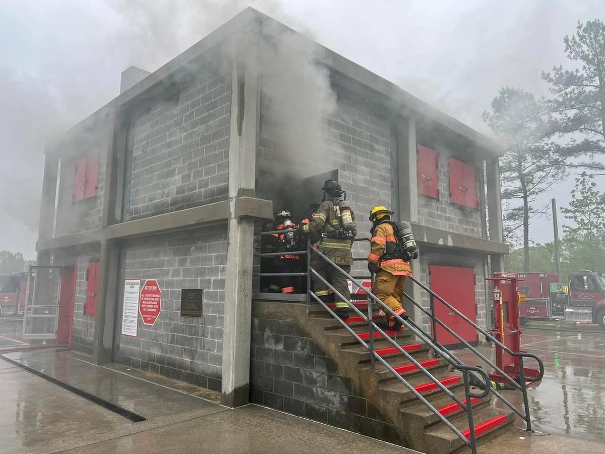 Crew working the exterior stairs of the burn building during training