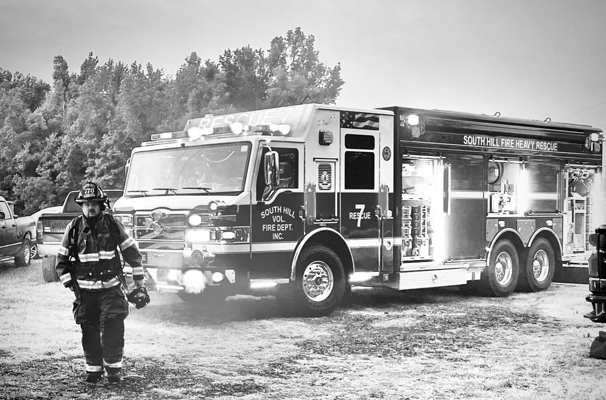 Derek Hazelwood walking from Rescue 7 with his mask in hand, South Hill Fire Heavy Rescue