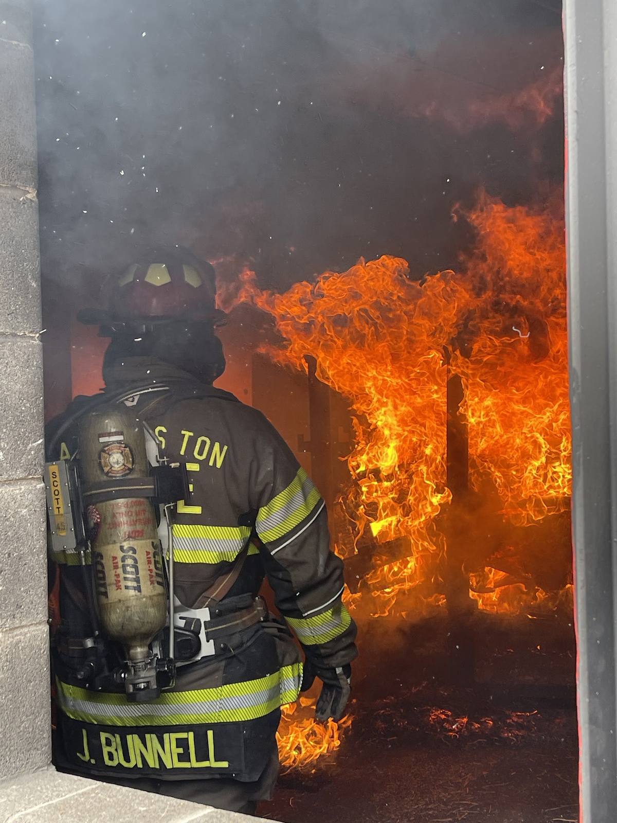 Firefighter at a fully involved doorway during live fire training
