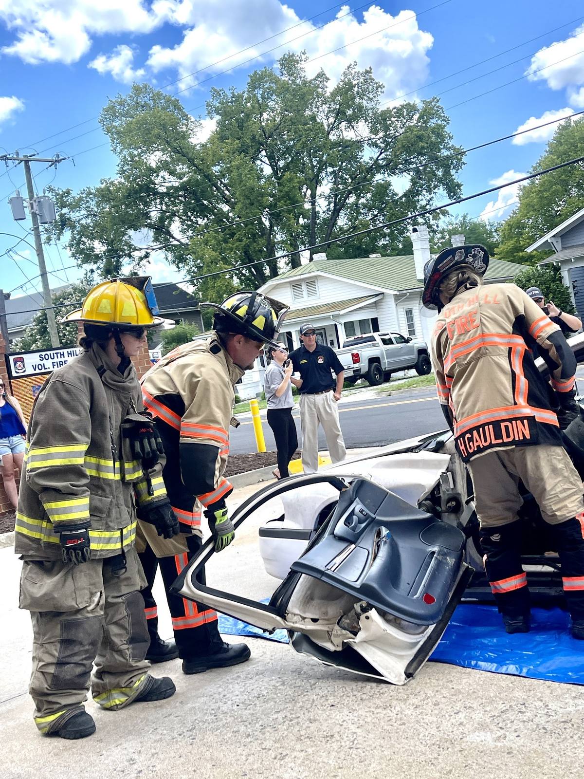South Hill crew removing a vehicle roof during a residential street extrication