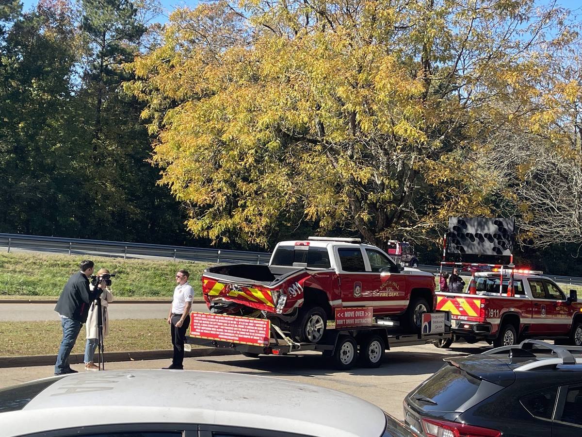 Media covering the wrecked command truck display at a Virginia Move Over Law event