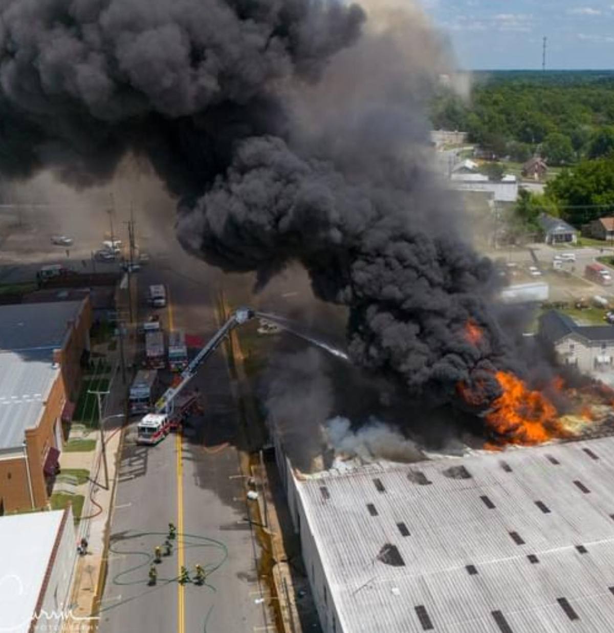 Heavy black smoke rising from a commercial structure fire, aerial view, South Hill Virginia