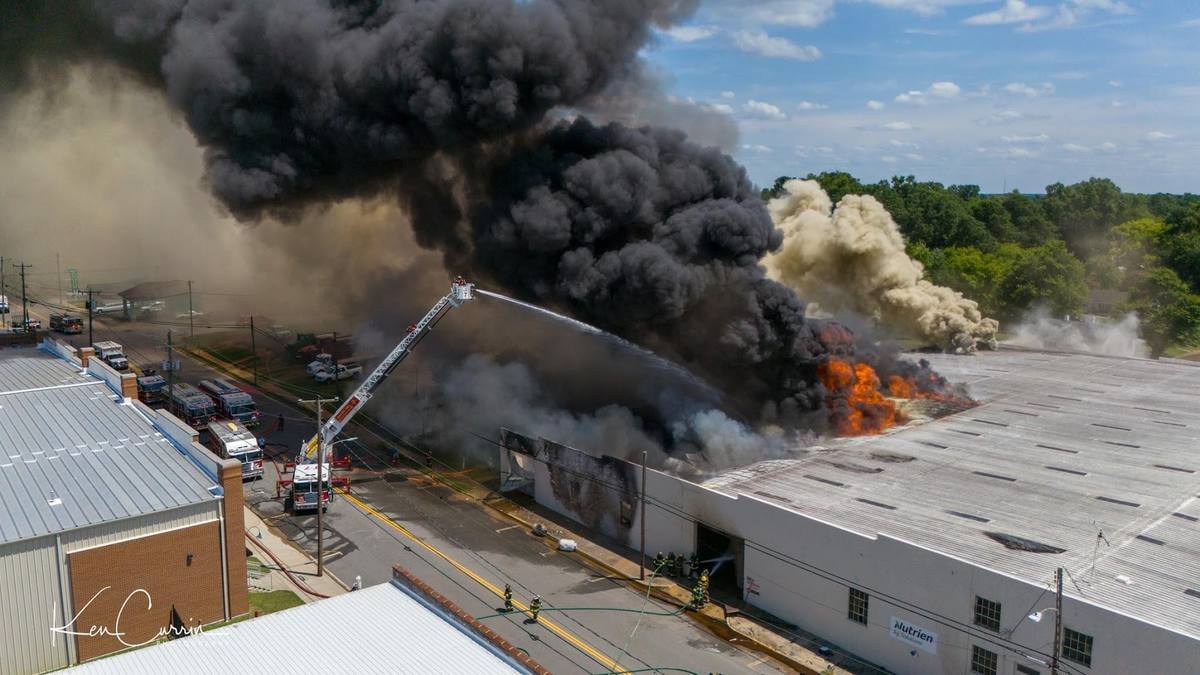 Ladder pipe operating on a commercial fire from above, South Hill Volunteer Fire Department