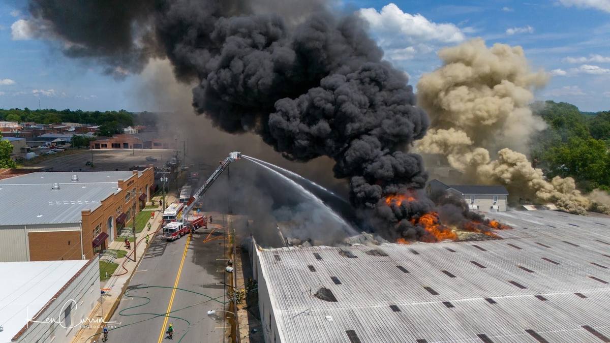 Wide aerial view of crews working a large commercial structure fire