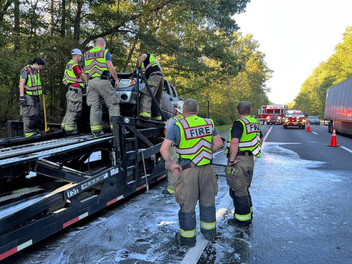 Crew repacking equipment on the highway shoulder after a crash response, Interstate 85