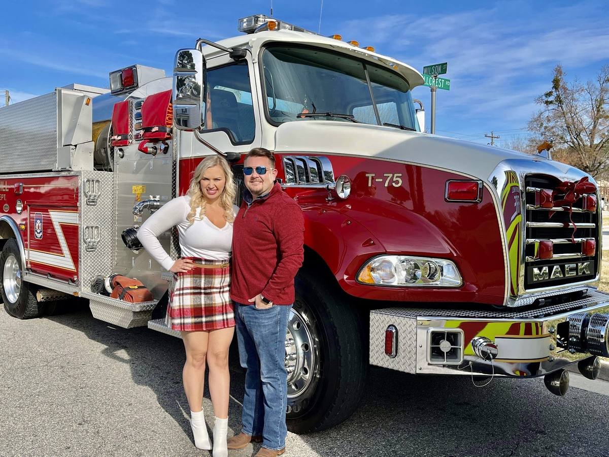 Derek Hazelwood and his wife Nina beside Tanker 75, South Hill Volunteer Fire Department