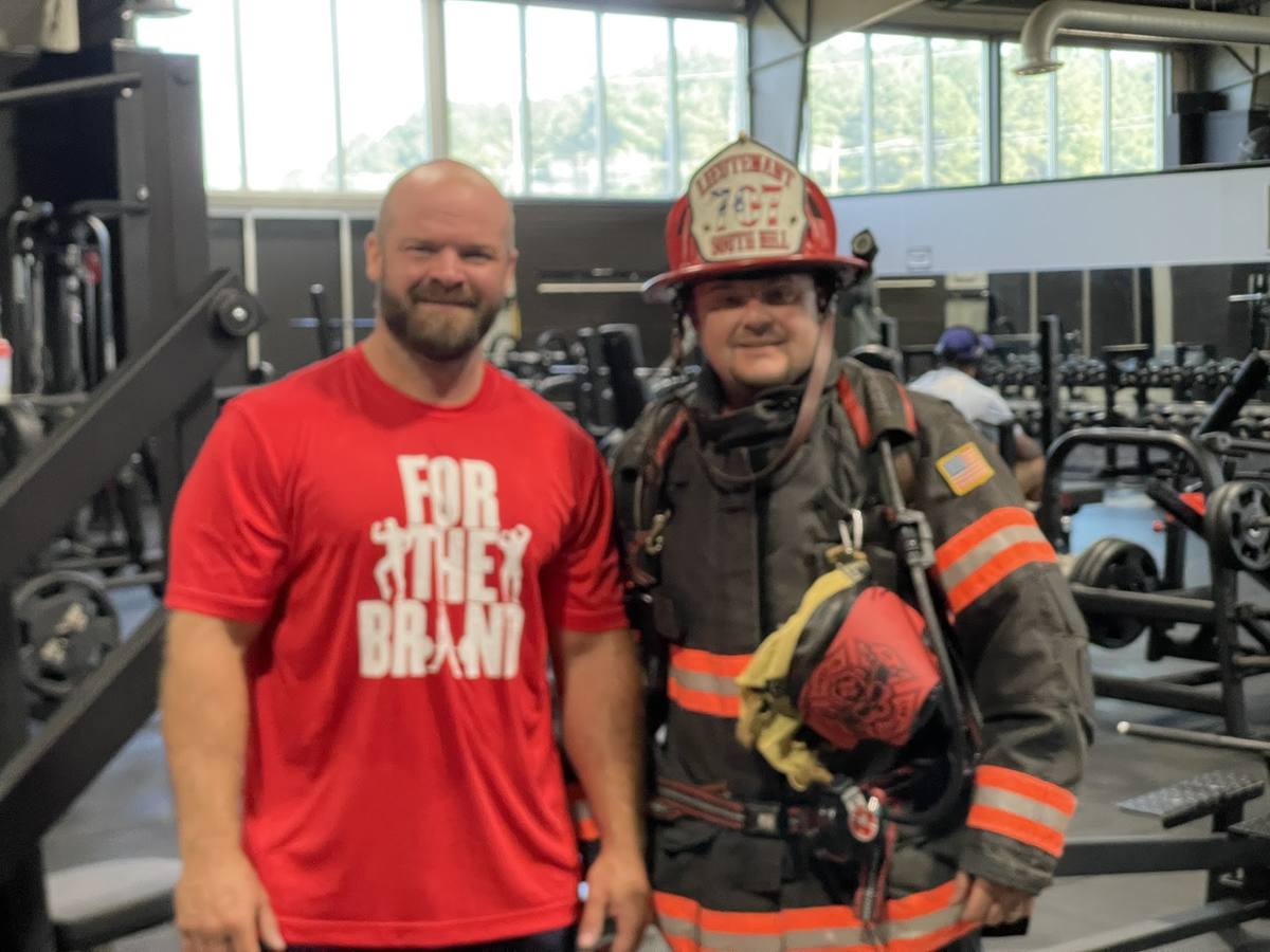 Derek Hazelwood in full turnout gear with William Crowder of Fit Club, South Hill Virginia, at the 9/11 memorial stair climb